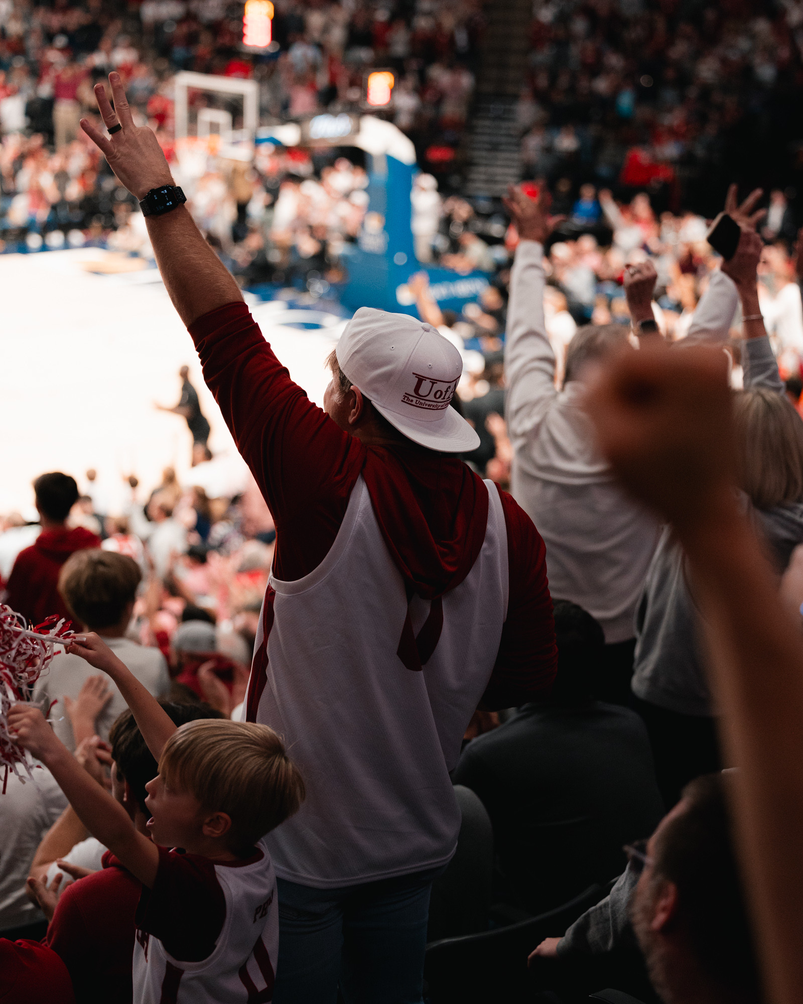 Families in crimson cheering in the stands